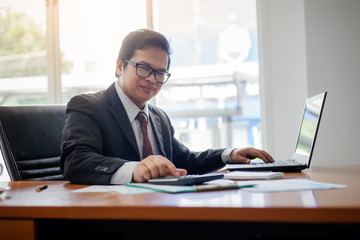 Business man working at office with laptop computer and documents financial reports