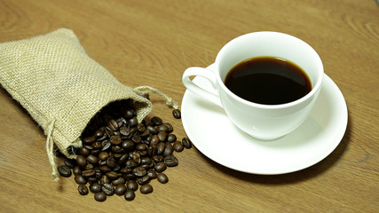 Coffee and coffee beans on wooden background