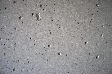 The texture of concrete, with cavities from under the air bubbles