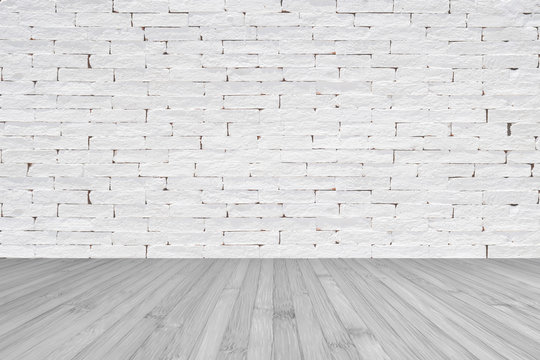 Grunge old aged brick wall painted in white color with wooden floor textured background in light grey with vignette