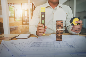 Construction engineering. Architect drawing blueprints and engineering tools on workplace