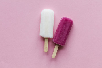 pink and white summer ice lollies on a pink background