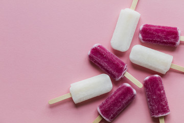 pink and white summer ice lollies on a pink background