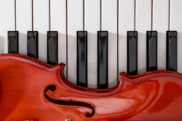 classical violin on white and black piano keys close-up background