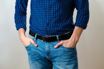 Close up of a man with hands in pockets