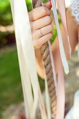 female hand with wedding ring holding rope ,closeup