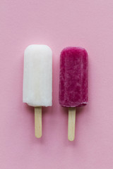pink and white summer ice lollies on a pink background