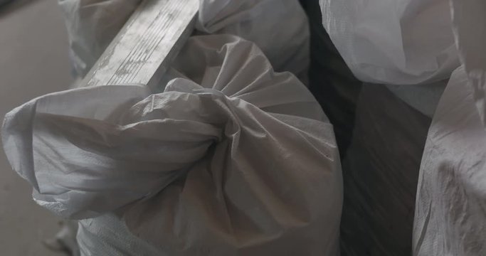Slow motion handheld shot of construction garbage in bags