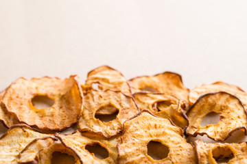 Healthy snack. Tasty dried apple and pear rings chips on light background
