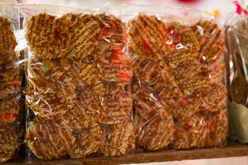 Homemade rice cake snacks for sale on a snack stand, floating market near Bangkok, Thailand