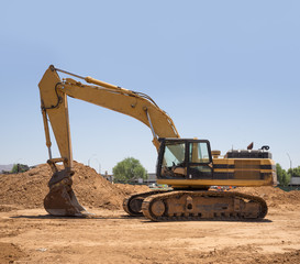 Fototapeta na wymiar Construction site with backhoe excavator