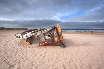 Wrecked fishing boat at Crow point near Braunton Devon Uk
