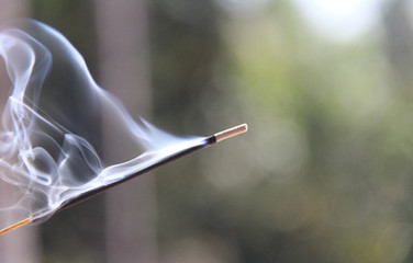 Incense stick and smoke from incense burning. Beautiful smoke. Blurred background and design with...