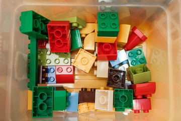 Colorful plastic constructor for children in the box. Top view