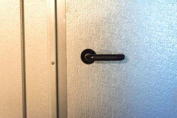 metal black handle on a silver door