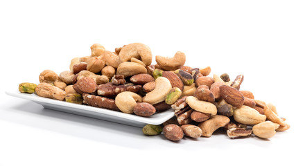 Assorted nuts of different kinds on a small white plate