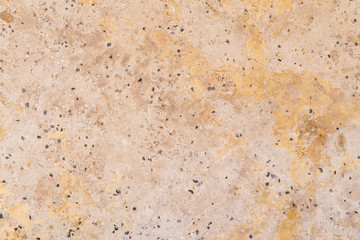 Full frame background texture of orange/peachy cement flooring or wall with small rocks.