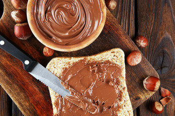 Homemade hazelnut spread with toast and in wooden bowl for breakfast. Hazelnut Nougat cream