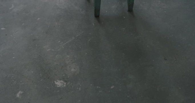 Slow motion handheld shot of old stool in empty room during renovation