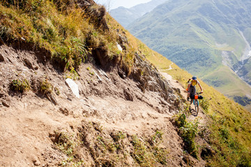 Fototapeta premium Mountain biker is travelling in the highlands of Tusheti region, Georgia