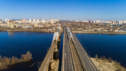 Obraz premium Aerial view of the Kiev city, Ukraine. Dnieper river with bridges. Darnitskiy bridge