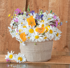 Arrangement of wildflowers on a wood background