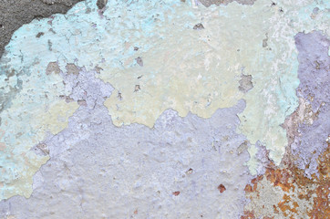 Detail of an old rough wall with blue, violet and grey layers suitable as a background