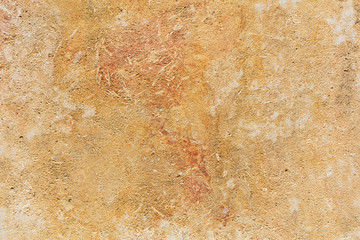 Weathered yellow limestone wall background