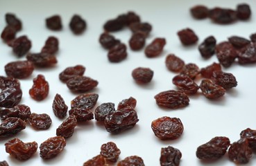 Dried raisins on a white background