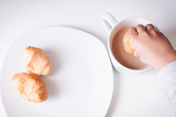 White plate of sweet croissants and coffe