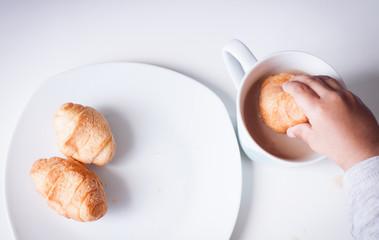White plate of sweet coissants and coffe