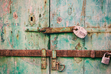 Locked door. Closed old rusty padlocks on a distressed wooden door