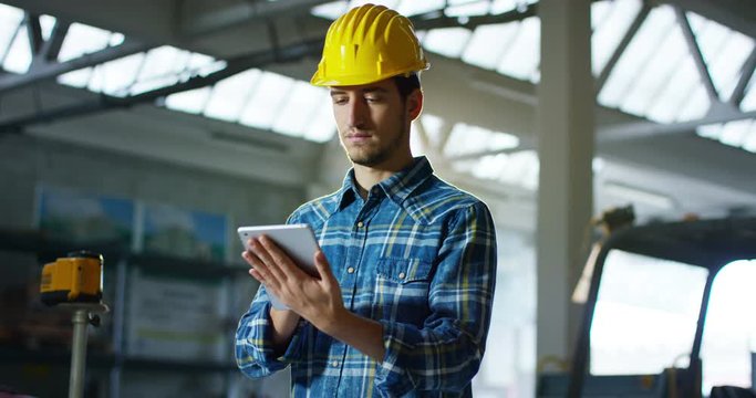 On a construction site, a worker or an engineer or architect controls the design and construction of the building with high energy savings. Concept: construction, worker, engineering, design.