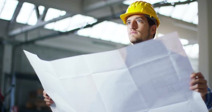 on a construction site, a worker or an engineer or architect controls the design and construction of the building with high energy savings. Concept: construction, worker, engineering, design.