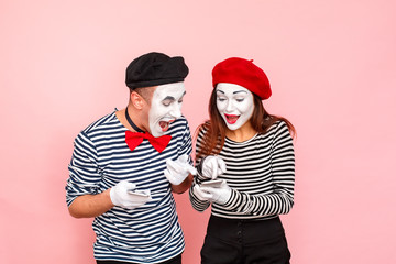 Сouple look at the phones each other and toothy smiling