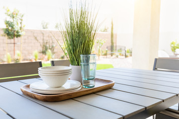 Outdoor Patio Setting with Dishes and Glasses on Tray