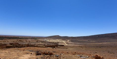scenic desert landscape in Morocco, assa-zag, moroccan rocky desert landscape with plants and mountain range