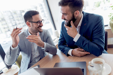 Business colleagues in modern office using laptop