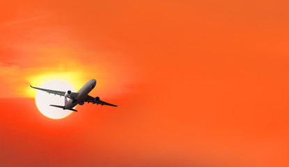 Plane takes off at sunrise background
