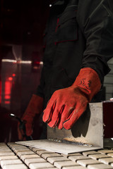 red protective leather welder gloves are put on hands