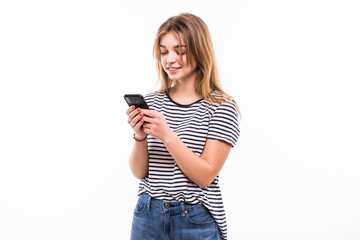 Front view portrait of a young smiling caucasian tenn sending an sms, on white background