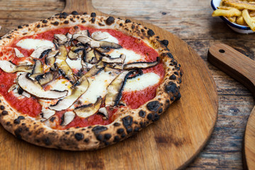 Portobello Italian pizza on the thin base with melted mozzarella cheese, mushrooms and tomato