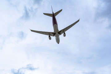 Under view of Airplane in the cloudy sky for background