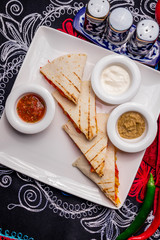 Quesadilla with chicken and sauces