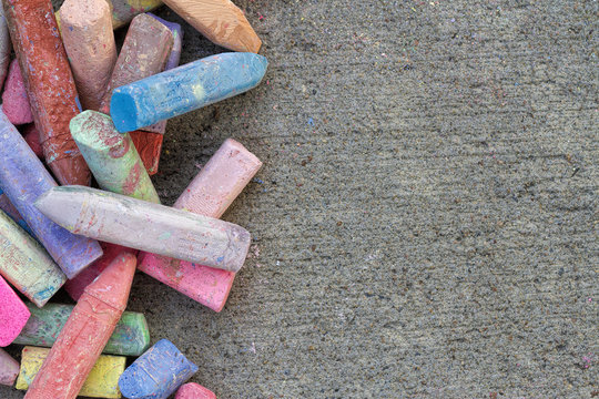 Various Colors of Chalk on a Paved Sidewalk