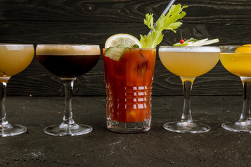 assorted cocktails on black concrete
