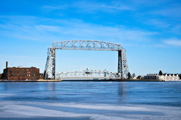 Duluth Minnesota aerial lift bridge with ice on sunny day