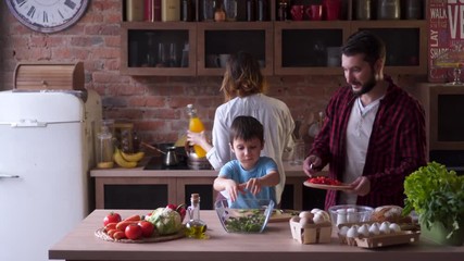 family of four cooking at the kitchen tasty dinner - Powered by Adobe