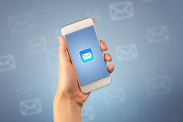 Female fingers touching smartphone with mail icon on it