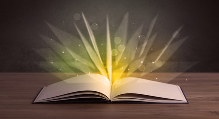 Yellow lights spreading from an open book 